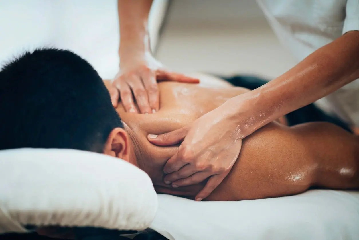 A person receiving a back massage.