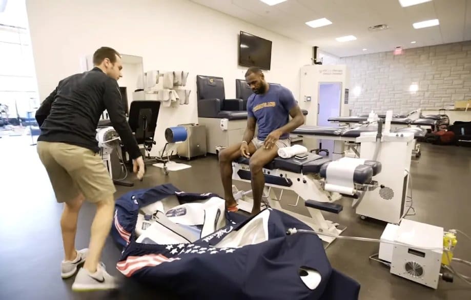 Two men in a room with a medical equipment.