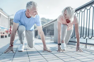 A man and woman in running position.