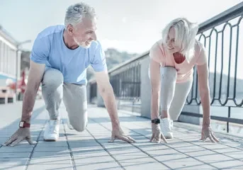 A man and woman in running position.